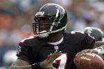 30 Dec 2001: Michael Vick # 7 of the Atlanta Falcons looks for an open man down field against the Miami Dolphins in the second quarter at Pro Player Stadium in Miami Florida. DIGITAL IMAGE. Mandatory Credit: Eliot Schechter/Getty Images