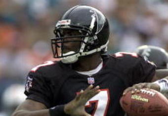 30 Dec 2001: Michael Vick # 7 of the Atlanta Falcons looks for an open man down field against the Miami Dolphins in the second quarter at Pro Player Stadium in Miami Florida. DIGITAL IMAGE. Mandatory Credit: Eliot Schechter/Getty Images
