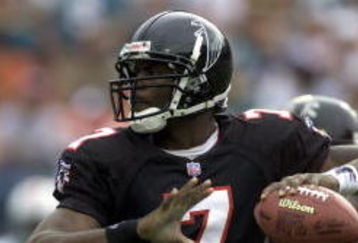 30 Dec 2001: Michael Vick # 7 of the Atlanta Falcons looks for an open man down field against the Miami Dolphins in the second quarter at Pro Player Stadium in Miami Florida. DIGITAL IMAGE. Mandatory Credit: Eliot Schechter/Getty Images