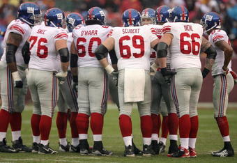 LANDOVER, MD - NOVEMBER 30:  Shaun O'Hara #60, Rich Seubert #69 and David Diehl #66 of the New York Giants huddle on the field against the Washington Redskins during their game at FedEx Field on November 30, 2008 in Landover, Maryland. (Photo by Streeter Lecka/Getty Images)