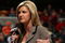 INDIANAPOLIS - MARCH 12:  ESPN's Erin Andrews performs an on camera report as the Michigan Wolveriens play against the Iowa Hawkeyes during the first round of the Big Ten Men's Basketball Tournament at Conseco Fieldhouse on March 12, 2009 in Indianapolis, Indiana.  (Photo by Jonathan Daniel/Getty Images)