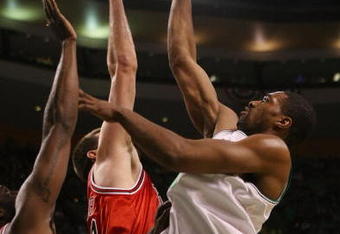 BOSTON - APRIL 18:  Leon Powe #0 of the Boston Celtics takes a shot over Brad Miller #52 and Tim Thomas #2 of the Chicago Bulls in Game One of the Eastern Conference Quarterfinals during the 2009 NBA Playoffs at TD Banknorth Garden on April 18, 2009 in Boston, Massachusetts. NOTE TO USER: User expressly acknowledges and agrees that, by downloading and or using this photograph, User is consenting to the terms and conditions of the Getty Images License Agreement. (Photo by Elsa/Getty Images)