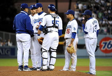 LOS ANGELES, CA - OCTOBER 13:  Pitcher Hong-Chih Kuo #56 of the Los Angeles Dodgers is taken out in the eighth inning by manager Joe Torre #6 during Game Four of the National League Championship Series against the Philadelphia Phillies during the 2008 MLB playoffs on October 13, 2008 at Dodger Stadium in Los Angeles, California.  (Photo by Harry How/Getty Images)