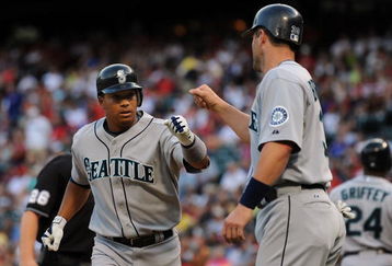 ARLINGTON, TX - JULY 31:  Second baseman Jose Lopez #4 celebrates a two-run home run with Russell Branyan #30 of the Seattle Mariners in the first inning against the Texas Rangers on July 31, 2009 at Rangers Ballpark in Arlington, Texas.  (Photo by Ronald Martinez/Getty Images)