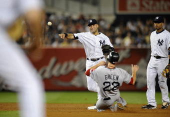 NEW YORK - AUGUST 09:  Derek Jeter #2  of the New York Yankees throws to first after forcing out Nick Green #22 of the Boston Red Sox in the third inning on August 9, 2009 at Yankee Stadium in the Bronx Borough of New York City.  Robinson Cano #24 of the New York Yankees looks on at right. (Photo by Jeff Zelevansky/Getty Images)