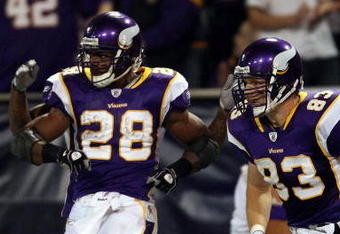 MINNEAPOLIS - JANUARY 4:  Adrian Peterson #28 of the Minnesota Vikings celebrates his touchdown with teammate Jeff Dugan #83 in the first half against the Philadelphia Eagles during the NFC Wild Card playoff game on January 4, 2009 at the Hubert H. Humphrey Metrodome in Minneapolis, Minnesota. (Photo by Elsa/Getty Images)