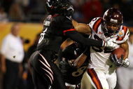 MIAMI - JANUARY 01:  DeAngelo Smith #6 of the Cincinnati Bearcats tries to tackle Darren Evans #32 of the Virginia Tech Hokies during the FedEx Orange Bowl at Dolphin Stadium on January 1, 2009 in Miami, Florida.  (Photo by Doug Benc/Getty Images)