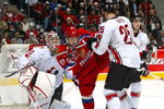 VANCOUVER - JANUARY 5: Cam Barker #25 of Team Canada checks Sergei Shirokov #29 of Team Russia as goaltender Justin Pogge #33 gets into position during their gold medal game at the World Junior Hockey Championships at General Motors Place in Vancouver, Canada.  Team Canada beat Team Russia 5-0 to win the gold medal.   (Photo by Dave Sandford/Getty Images)