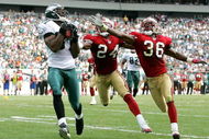 PHILADELPHIA - SEPTEMBER 18:  Terrell Owens #81 of the Philadelphia Eagles catches a pass for a touchdown as Mike Rumph #24 and Shawntae Spencer #36 of the San Francisco 49ers defend during the first half of the game on September 18, 2005 at Lincoln Financial Field in Philadelphia, Pennsylvania.  (Photo by Jamie Squire/Getty Images)