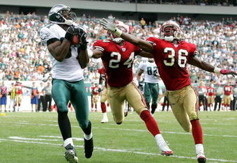 PHILADELPHIA - SEPTEMBER 18:  Terrell Owens #81 of the Philadelphia Eagles catches a pass for a touchdown as Mike Rumph #24 and Shawntae Spencer #36 of the San Francisco 49ers defend during the first half of the game on September 18, 2005 at Lincoln Financial Field in Philadelphia, Pennsylvania.  (Photo by Jamie Squire/Getty Images)