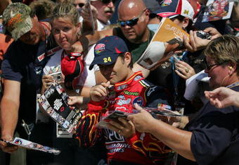 BROOKLYN, MI - AUGUST 15:  Jeff Gordon, driver of the #24 DuPont Chevrolet, signs autographs for fans during qualifying for the NASCAR Sprint Cup Series 3M Performance 400 at Michigan International Speedway on August 15, 2008 in Brooklyn, Michigan.  (Photo by Marc Serota/Getty Images for NASCAR)