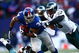 EAST RUTHERFORD, NJ - JANUARY 11: Derrick Ward #34 of the New York Giants runs against Darren Howard #90 of the Philadelphia Eagles during the NFC Divisional Playoff Game on January 11, 2009 at Giants Stadium in East Rutherford, New Jersey.  (Photo by Chris McGrath/Getty Images)