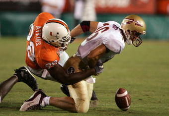 MIAMI - SEPTEMBER 10:  Quarterback Chris Rix #16 of the Florida State University Seminoles fumbles as he gets tackled by Baraka Atkins #98 of the University of Miami Hurricanes in the second half on September 10, 2004 at the Orange Bowl Stadium in Miami, Florida.  (Photo by Robert Laberge/Getty Images)