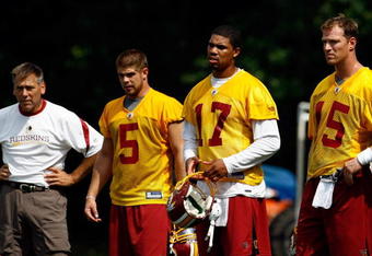 ASHBURN, VA - JULY 30:  Washington Redskins Head Coach Jim Zorn (L) works with quarterbacks Jason Campbell #17, Colt Brennan #5 and Todd Collins #15 during opening day of training camp July 30, 2009 in Ashburn, Virginia.  (Photo by Win McNamee/Getty Images)