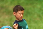 N368044 04: (MAGAZINES OUT) Elian Gonzalez gets tagged out during a kickball game April 20, 2000 in Miami. He was playing with family and friends in the yard of the home where he is staying in Miami's Little Havana district. (Photo by Joe Raedle)