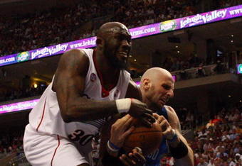 PHILADELPHIA - APRIL 26:  Reggie Evans #33 of the Philadelphia 76ers battles for the ball against Marcin Gortat #13 of the Orlando Magic during Game Four of the Eastern Conference Quarterfinals during the 2009 NBA Playoffs at the Wachovia Center on April 26, 2009 in Philadelphia, Pennsylvania. NOTE TO USER: User expressly acknowledges and agrees that, by downloading and/or using this Photograph, user is consenting to the terms and conditions of the Getty Images License Agreement.  (Photo by Jim McIsaac/Getty Images)
