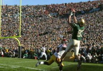 SOUTH BEND, IN - OCTOBER 15:  Wide receiver Jeff Samardzija #83 of the University of Notre Dame Fighting Irish makes a catch near cornerback Justin Wyatt #24 of the University of Southern California Trojans on October 15, 2005 at Notre Dame Stadium in South Bend, Indiana. USC defeated Notre Dame 34-31. (Photo by Jonathan Daniel/Getty Images)