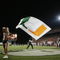 MIAMI - OCTOBER 14:  A male Miami Hurricanes cheerleader waves a giant flag while a female cheerleader performs during the game against the Florida International Panthers at the Orange Bowl on October 14, 2006 in Miami, Florida. Miami won 35-0.  (Photo by Marc Serota/Getty Images)