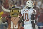 PASADENA, CA - JANUARY 04:  Quarterback Vince Young #10 of the Texas Longhorns walks past the Longhorns' mascot near the start of the BCS National Championship Rose Bowl Game against the USC Trojans at the Rose Bowl on January 4, 2006 in Pasadena, California.  Texas defeated USC 41-38.  (Photo by Lisa Blumenfeld/Getty Images)
