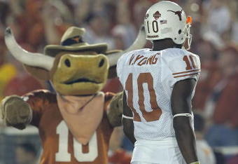 PASADENA, CA - JANUARY 04:  Quarterback Vince Young #10 of the Texas Longhorns walks past the Longhorns' mascot near the start of the BCS National Championship Rose Bowl Game against the USC Trojans at the Rose Bowl on January 4, 2006 in Pasadena, California.  Texas defeated USC 41-38.  (Photo by Lisa Blumenfeld/Getty Images)