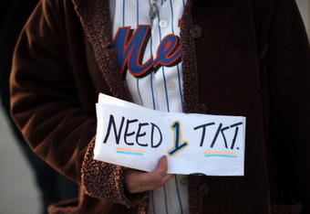 NEW YORK - APRIL 13:  A fan holds a sign looking for game tickets before the start of the Opening Day game between the San Diego Padres and the New York Mets at Citi Field on April 13, 2009 in the Flushing neighborhood of the Queens borough of New York City. This is the first regular season MLB game being played at the new venue which replaced Shea stadium as the Mets home field.