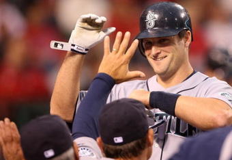 ANAHEIM, CA - APRIL 24:  Russell Branyan #30 of the Seattle Mariners high-fives teamates in the dugout after hitting a home run in the second inning against the Los Angeles Angels of Anaheim on April 24, 2009 at Angel Stadium in Anaheim, California.  (Photo by Stephen Dunn/Getty Images)