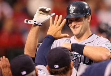 ANAHEIM, CA - APRIL 24:  Russell Branyan #30 of the Seattle Mariners high-fives teamates in the dugout after hitting a home run in the second inning against the Los Angeles Angels of Anaheim on April 24, 2009 at Angel Stadium in Anaheim, California.  (Photo by Stephen Dunn/Getty Images)