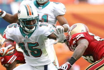 MIAMI - DECEMBER 14:  Wide receiver Davone Bess #15 of the Miami Dolphins breaks through for extra yardage on a kick return while taking on the San Francisco 49ers at Dolphin Stadium on December 14, 2008 in Miami, Florida. The Dolphins defeated the 49ers 14-9.  (Photo by Doug Benc/Getty Images)