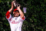 CHICAGO - AUGUST 12: (ALTERNATIVE CROP) Shane Victorino #8 of the Philadelphia Phillies is hit by a beer thrown by a fan in the bleachers as he makes a catch of a fly ball hit by Jake Fox of the Chicago Cubs in the 5th inning on August 12, 2009 at Wrigley Field in Chicago, Illinois.  (Photo by Jonathan Daniel/Getty Images)