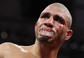 NEW YORK - JUNE 13:  Miguel Cotto fights with a cut after an accidental  head butt by Joshua Clottey during their WBO Welterweight title fight at Madison Square Garden  on June 13, 2009 in New York, New York.  (Photo by Al Bello/Getty Images)