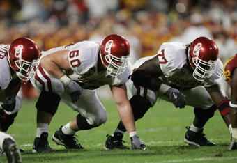 MIAMI - JANUARY 4:  Offensive linemen Wes Sims #60 and Davin Joseph #77 of the Oklahoma Sooners line up against the USC Trojans in the 2005 FedEx Orange Bowl National Championship on January 4, 2005 at Pro Player Stadium in Miami, Florida. USC defeated Oklahoma 55-19. (Photo by Brian Bahr/Getty Images)