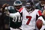 PHILADELPHIA - DECEMBER 31:  Michael Vick #7 of the Atlanta Falcons scrambles under pressure from Darren Howard #90 of the Philadelphia Eagles in NFL action December 31, 2006 at Lincoln Financial Field in Philadelphia, Pennsylvania. The Eagles defeated the Falcons 24-17.  (Photo by Jim McIsaac/Getty Images)