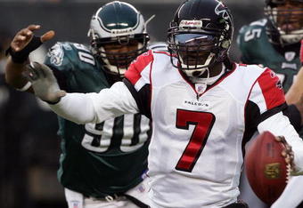 PHILADELPHIA - DECEMBER 31:  Michael Vick #7 of the Atlanta Falcons scrambles under pressure from Darren Howard #90 of the Philadelphia Eagles in NFL action December 31, 2006 at Lincoln Financial Field in Philadelphia, Pennsylvania. The Eagles defeated the Falcons 24-17.  (Photo by Jim McIsaac/Getty Images)