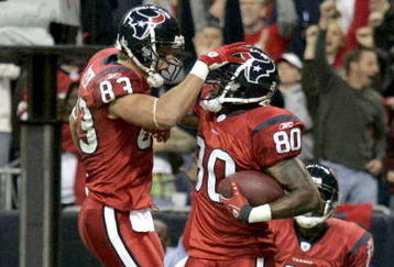 HOUSTON - DECEMBER 13:  Kevin Walter #83 celebrates a touchdown with Andre Johnson #80 of the Houston Texans during the NFL game against the Denver Broncos at  Reliant Stadium on December 13, 2007 in Houston, Texas. (Photo by Thomas B.  Shea/Getty Images)