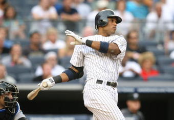 NEW YORK - AUGUST 12:  Robinson Cano #24 of the New York Yankees hits the game winning single against the Toronto Blue Jays during the MLB game on August 12, 2009 at Yankee Stadium in the Bronx borough of New York City.  The Yankees won 4-3 in 11 innings. (Photo by Nick Laham/Getty Images)