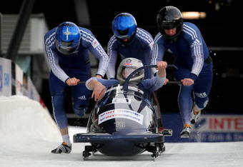 WHISTLER, BC - FEBRUARY 07:  Driver Lee Johnston of Great Britain enters the sled as his team pushes from the start in the first heat as they went on to finish 12th in the men's four man bobsleigh finals at the FIBT Bobsleigh and Skeleton World Cup at the Whistler Sliding Center on February 7, 2009 in Whistler, Canada.  (Photo by Doug Pensinger/Getty Images)