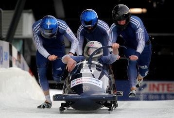 WHISTLER, BC - FEBRUARY 07:  Driver Lee Johnston of Great Britain enters the sled as his team pushes from the start in the first heat as they went on to finish 12th in the men's four man bobsleigh finals at the FIBT Bobsleigh and Skeleton World Cup at the Whistler Sliding Center on February 7, 2009 in Whistler, Canada.  (Photo by Doug Pensinger/Getty Images)