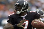 30 Dec 2001: Michael Vick # 7 of the Atlanta Falcons looks for an open man down field against the Miami Dolphins in the second quarter at Pro Player Stadium in Miami Florida. DIGITAL IMAGE. Mandatory Credit: Eliot Schechter/Getty Images