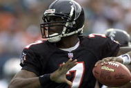 30 Dec 2001: Michael Vick # 7 of the Atlanta Falcons looks for an open man down field against the Miami Dolphins in the second quarter at Pro Player Stadium in Miami Florida. DIGITAL IMAGE. Mandatory Credit: Eliot Schechter/Getty Images