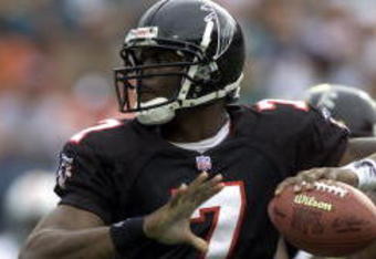 30 Dec 2001: Michael Vick # 7 of the Atlanta Falcons looks for an open man down field against the Miami Dolphins in the second quarter at Pro Player Stadium in Miami Florida. DIGITAL IMAGE. Mandatory Credit: Eliot Schechter/Getty Images