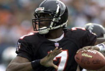 30 Dec 2001: Michael Vick # 7 of the Atlanta Falcons looks for an open man down field against the Miami Dolphins in the second quarter at Pro Player Stadium in Miami Florida. DIGITAL IMAGE. Mandatory Credit: Eliot Schechter/Getty Images