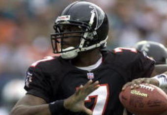 30 Dec 2001: Michael Vick # 7 of the Atlanta Falcons looks for an open man down field against the Miami Dolphins in the second quarter at Pro Player Stadium in Miami Florida. DIGITAL IMAGE. Mandatory Credit: Eliot Schechter/Getty Images