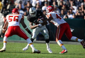 OAKLAND, CA - NOVEMBER 30: Darren McFadden #20 of the Oakland Raiders runs against Derrick Johnson #56 and Jarrad Page #44 of the Kansas City Chiefs during an NFL game on November 30, 2008 at the Oakland-Alameda County Coliseum in Oakland, California. (Photo by Jed Jacobsohn/Getty Images)
