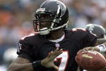30 Dec 2001: Michael Vick # 7 of the Atlanta Falcons looks for an open man down field against the Miami Dolphins in the second quarter at Pro Player Stadium in Miami Florida. DIGITAL IMAGE. Mandatory Credit: Eliot Schechter/Getty Images