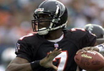 30 Dec 2001: Michael Vick # 7 of the Atlanta Falcons looks for an open man down field against the Miami Dolphins in the second quarter at Pro Player Stadium in Miami Florida. DIGITAL IMAGE. Mandatory Credit: Eliot Schechter/Getty Images