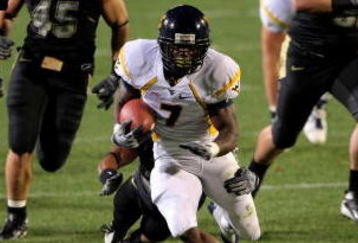 BOULDER, CO - SEPTEMBER 18:  Running back Noel Devine #7 of the West Virginia Mountaineers tries to elude the Colorado Buffaloes defense at Folsom Field September 18, 2008 in Boulder, Colorado. Colorado defeated West Virginia 17-14 in overtime.  (Photo by Doug Pensinger/Getty Images)
