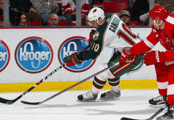 DETROIT - DECEMBER 7:  Marion Gaborik #10 of the Minnesota Wild tries to circle the net with the puck in a game against the Detroit Red Wings on December 7, 2007 at the Joe Louis Arena in Detroit, Michigan. (Photo by Claus Andersen/Getty Images)