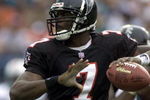 30 Dec 2001: Michael Vick # 7 of the Atlanta Falcons looks for an open man down field against the Miami Dolphins in the second quarter at Pro Player Stadium in Miami Florida. DIGITAL IMAGE. Mandatory Credit: Eliot Schechter/Getty Images