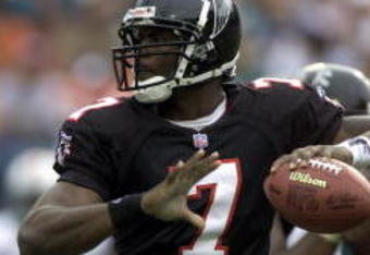 30 Dec 2001: Michael Vick # 7 of the Atlanta Falcons looks for an open man down field against the Miami Dolphins in the second quarter at Pro Player Stadium in Miami Florida. DIGITAL IMAGE. Mandatory Credit: Eliot Schechter/Getty Images