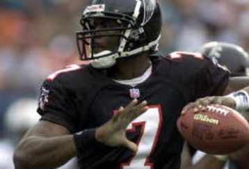 30 Dec 2001: Michael Vick # 7 of the Atlanta Falcons looks for an open man down field against the Miami Dolphins in the second quarter at Pro Player Stadium in Miami Florida. DIGITAL IMAGE. Mandatory Credit: Eliot Schechter/Getty Images
